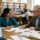 Research proposal writers mentoring a PhD scholar as they review an annotated proposal draft