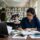 PhD assistance and guidance session with a mentor reviewing a doctoral scholar's thesis chapter in a library
