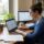 PhD research paper help — researcher reviewing an annotated journal manuscript in a university library