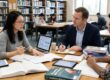 Research consulting services session with a PhD scholar and consultant reviewing a thesis draft
